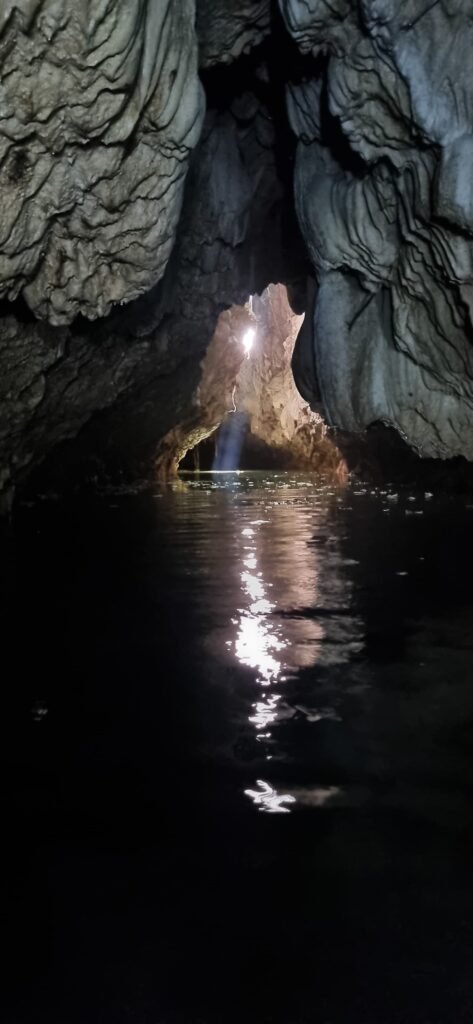 Natural light beam entering the Bayano cave and reflecting on the underground water